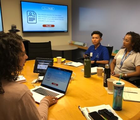 Young staff with computers have a working partnership with Disney