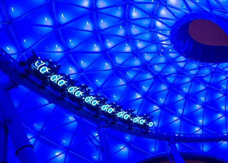 Tron roller coaster loops through wild neon lights